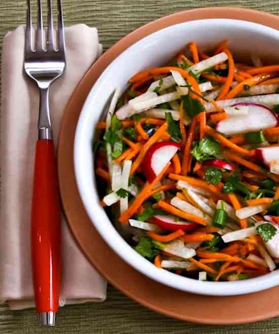 Jicama Carrot Radish Slaw close-up of salad in bowl with fork and napkin