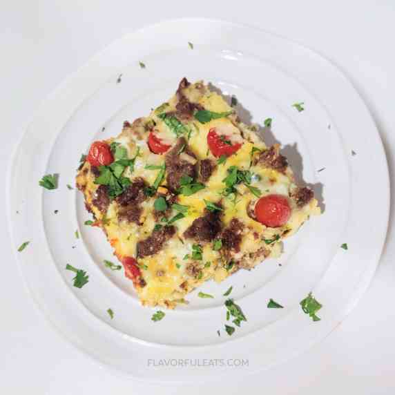 A big, square slice of Southwest Breakfast Casserole on a white plate