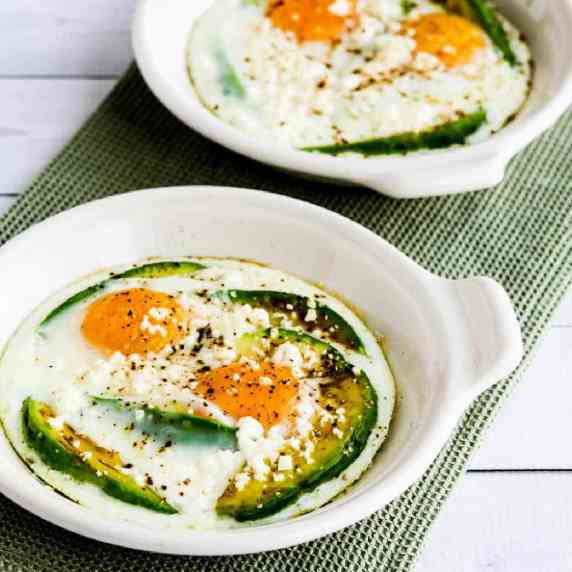 Baked Eggs with Avocado and Feta shown in two gratin dishes.