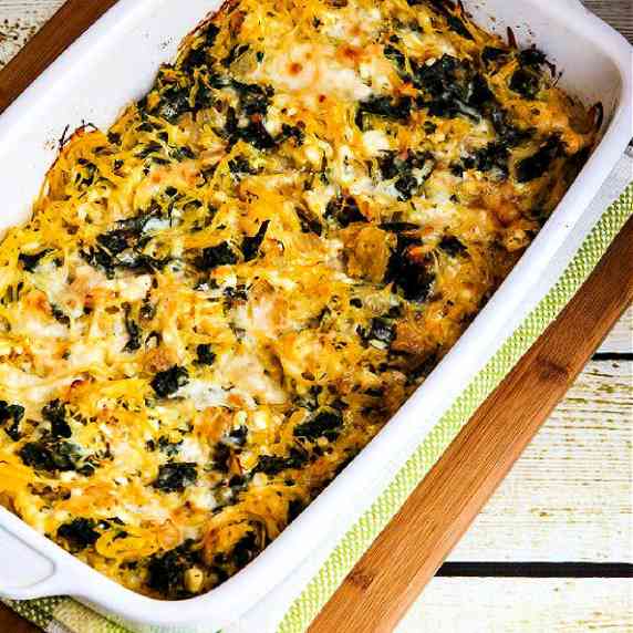 Twice-Baked Spaghetti Squash with Kale shown in baking dish on cutting board.