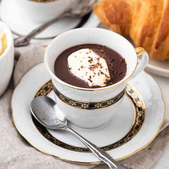 rich and creamy french hot chocolate topped with whipped cream and shavings of chocolate