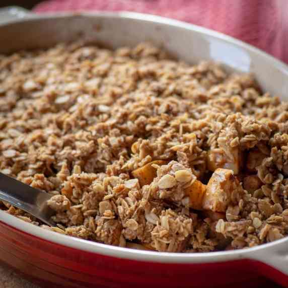 Apple crisp in a red baking dish.