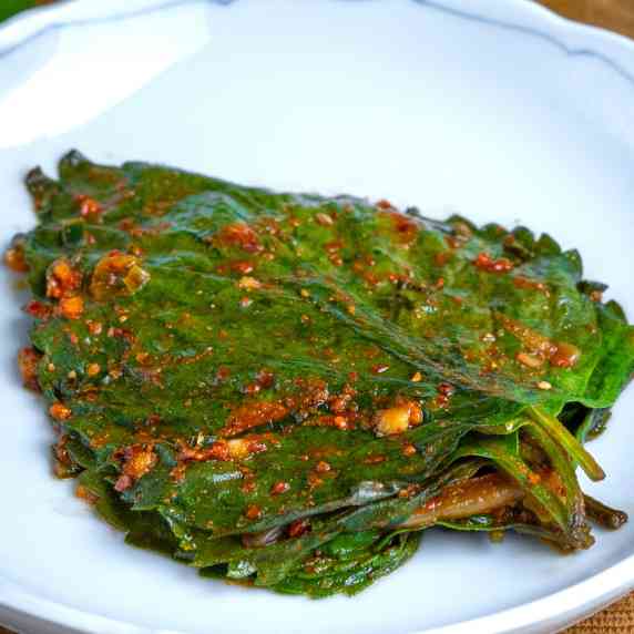 Freshly made stack of perilla leaf kimchi sitting on a plate