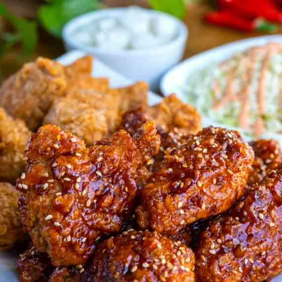 A display of naked and marinated wings with a side of slaw and Korean pickled radish's.