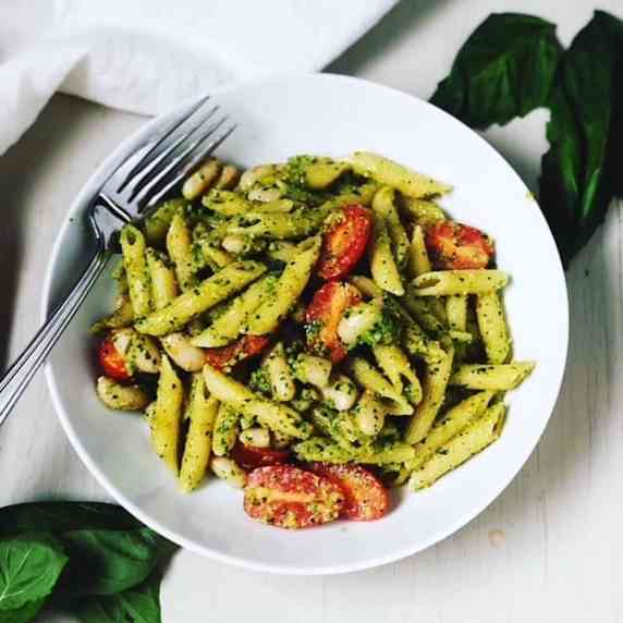 pesto pasta in bowl with a fork