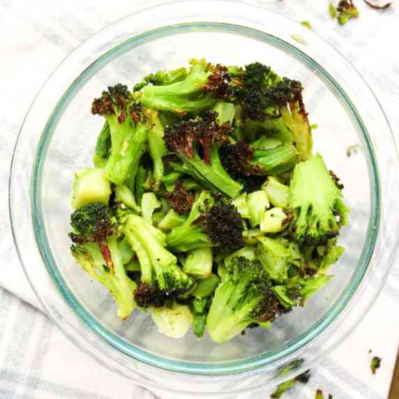 Air fryer frozen broccoli in a glass bowl.