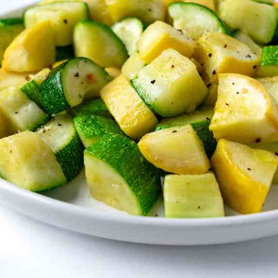 Air Fryer Zucchini and Yellow Squash on a white serving plate.
