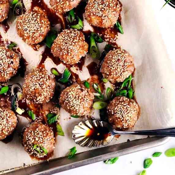 Asian pork meatballs on plate with sauce