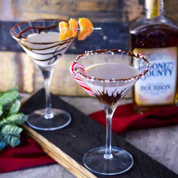 Bourbon Cream Chocolate Martinis on bourbon stave with bourbon and bourbon staves in background 
