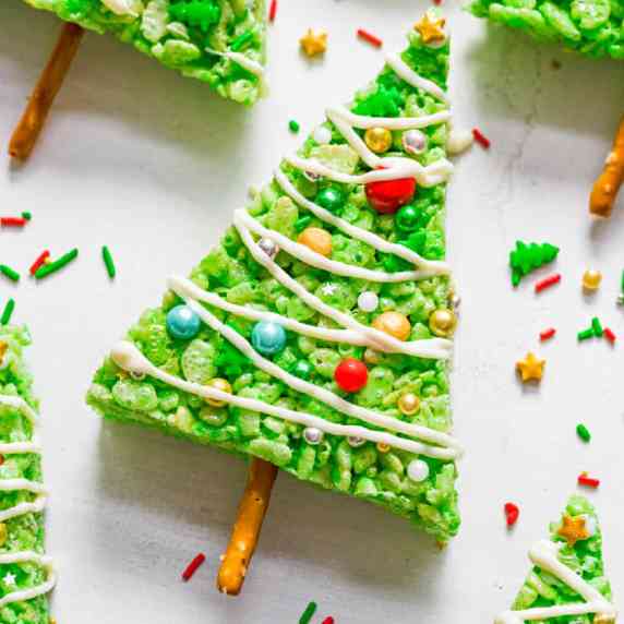 Close up zoom view of a green triangle Rice Krispie treat decorated like a Christmas tree.