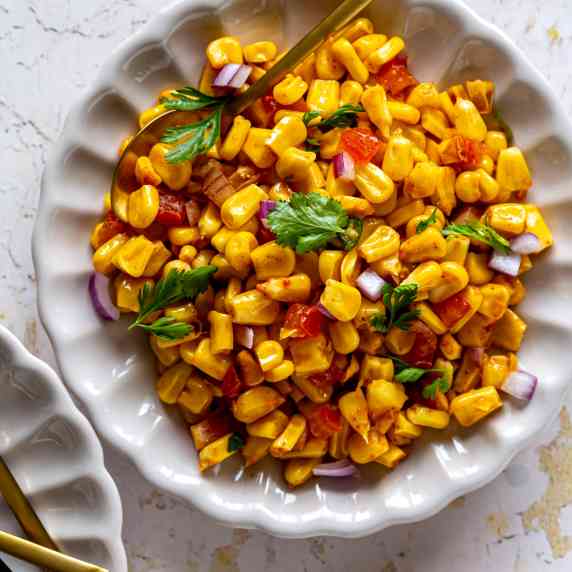 corn chaat served in a white plate