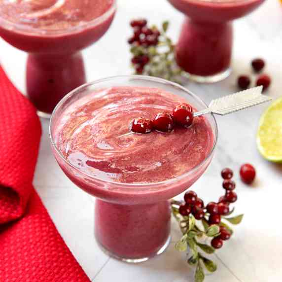 Glasses of cranberry smoothies on a table.