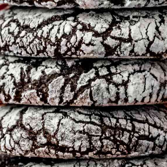 Gluten Free Chocolate Orange Crinkle Cookies close up view and stacked four on top of each other