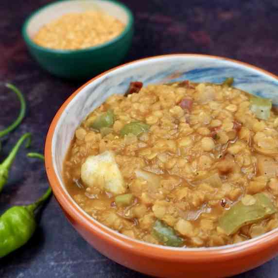 A bowl of spicy lentils with peppers