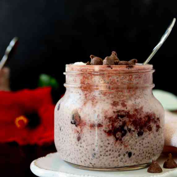 Jar of Cherry Chia Pudding with a Red Flower