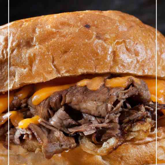 succulent thin sliced roast beef sandwich with rich velvety cheese sauce