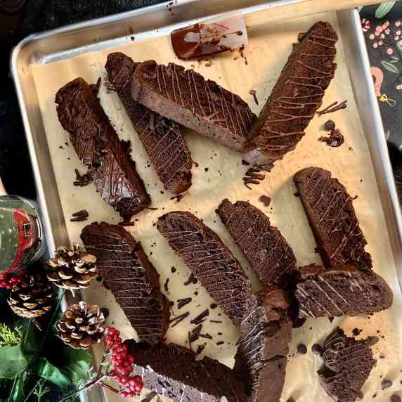 Double Chocolate Cake Mix Biscotti arranged on baking sheet with winter decor