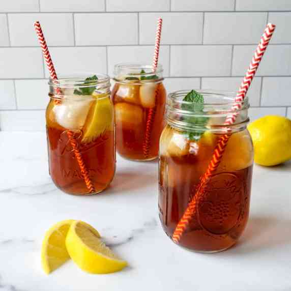 Earl Grey Iced Tea in mason jars with red and white straws.