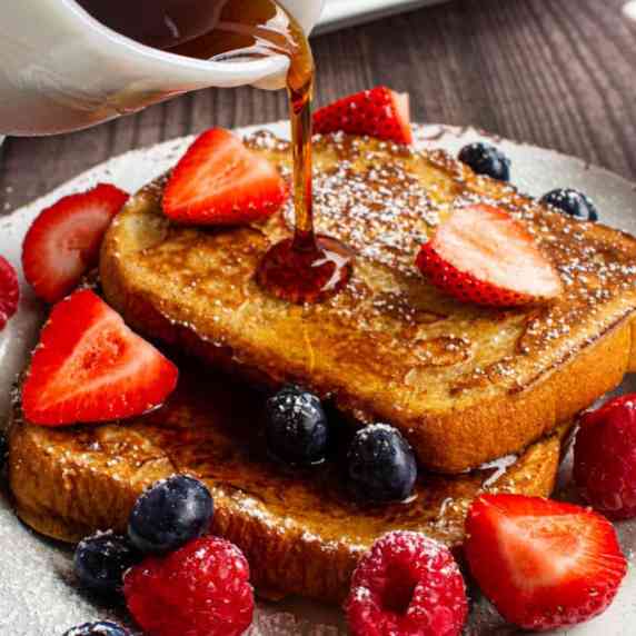 french toast with syrup being poured over