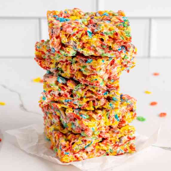 Fruity peeble rice crispy treats stacked on top of each other