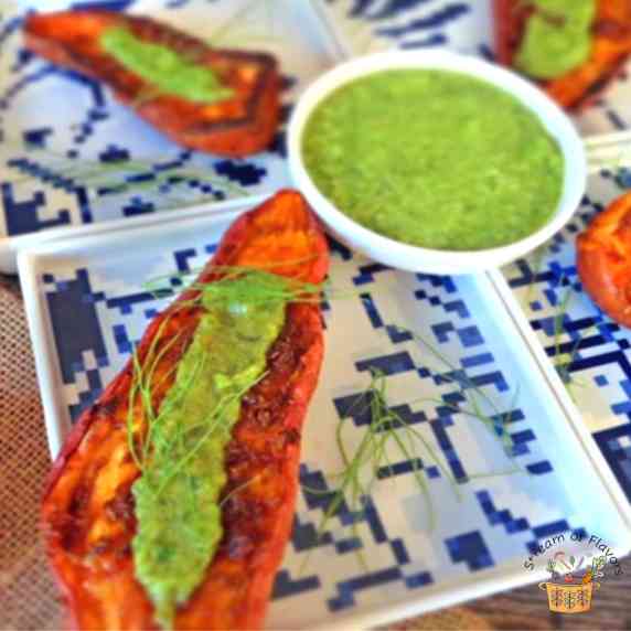 Grilled sweet potatoes with mint tahini sauce on blue and white plates