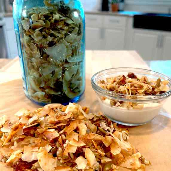 Honey Coconut Grain-Free Granola in a mason jar and topped on coconut yogurt cup