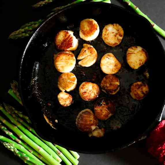 Pan Fried scallops in a cast-iron pan 
