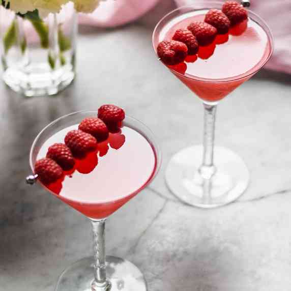 2 raspberry martinis with fresh raspberries