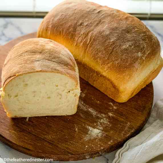 freshly baked sourdough sandwich bread in a serving board