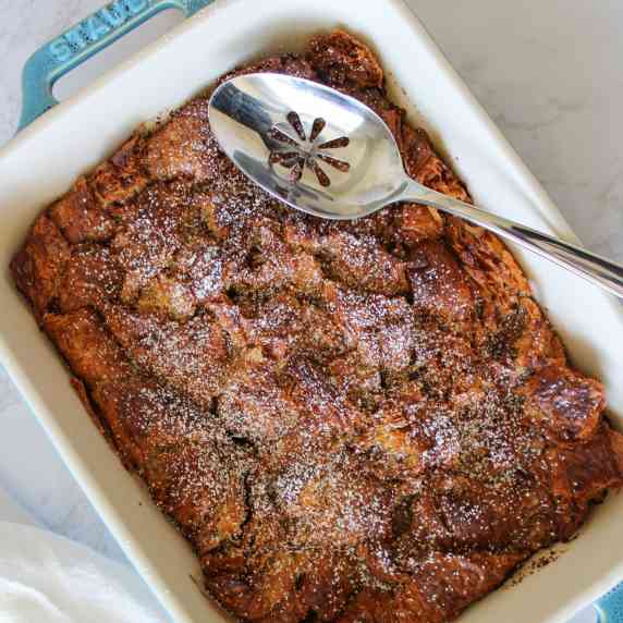 A baked french toast casserole made with croissants in a serving dish