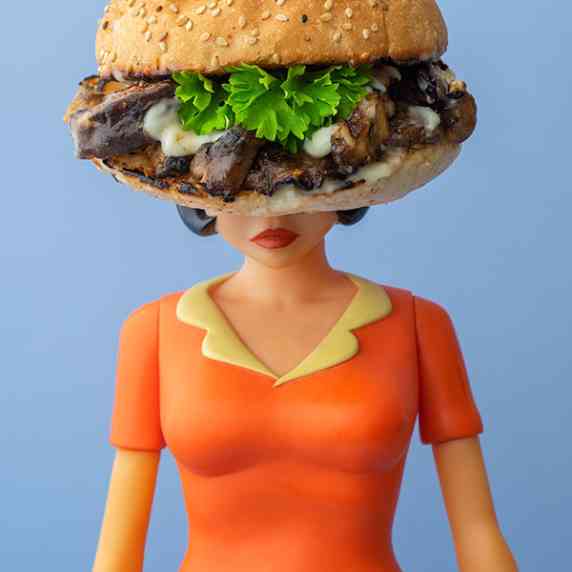 An action figure, Enid Coleslaw from Ghostworld, with a jerk mushroom burger for a head