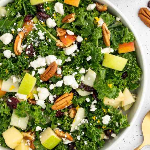 Large Fall Kale Apple Salad with Pecans in a White Bowl