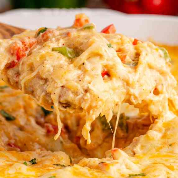 Each forkful of king ranch casserole is loaded with pulled chicken and soft tortillas smothered in a