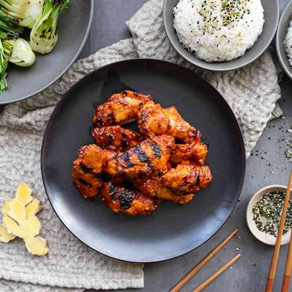 Korean BBQ Wings with grilled bok choy and chopsticks