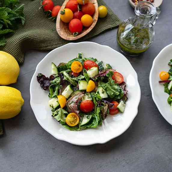 Salad with cherry tomatoes and cucumbers on a white plate