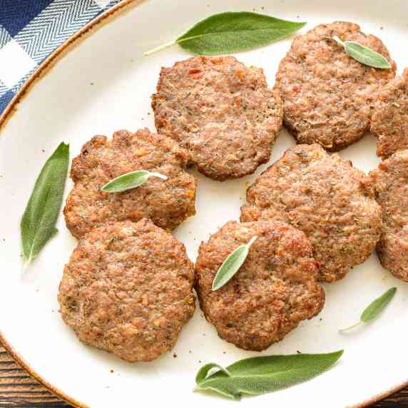 low fodmap breakfast sausage patties garnished with sage leaves on a platter