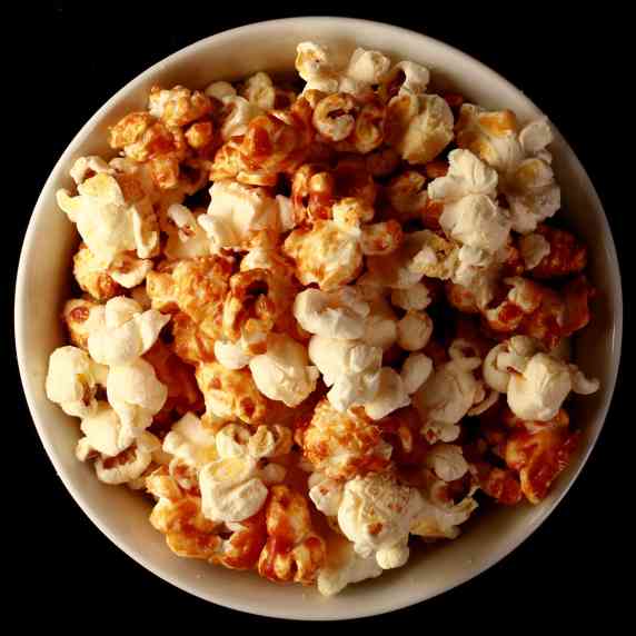 A bowl of maple caramel and white cheddar popcorn.
