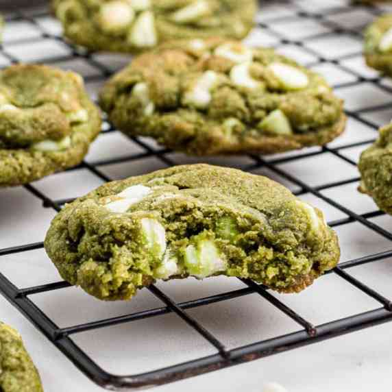 Close up of matcha cookies one with a bite taken out.