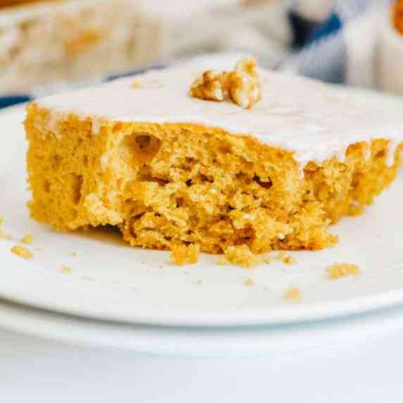 A slice of pumpkin honey cake on a white plate.