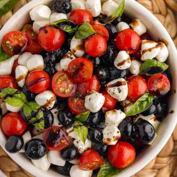 A classic Italian salad gets a delicious twist with the addition of blueberries, which also adds the