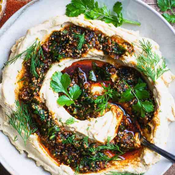 roasted lemon hummus and spicy herb oil in a bowl