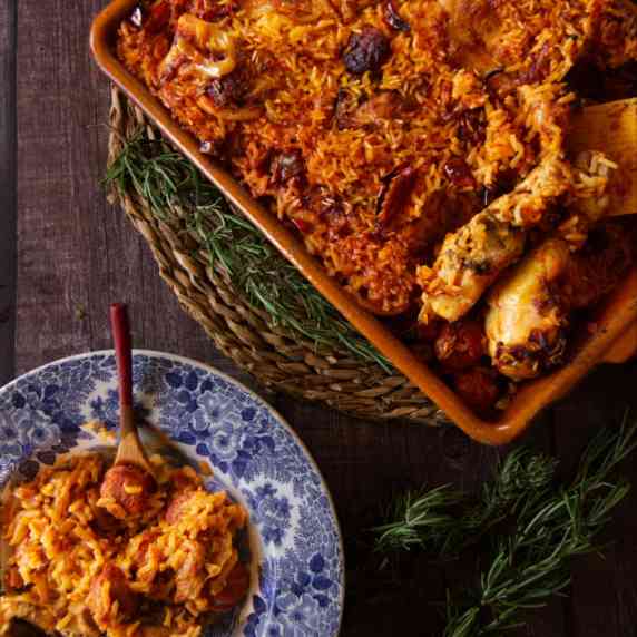 a large dish of spicy chicken, chorizo, and rice