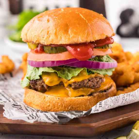 A big juicy smash burger is calling your name with its jagged edges and browned crust piled high on 