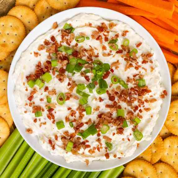 smoked gouda cheese dip topped with bacon bits and green onion