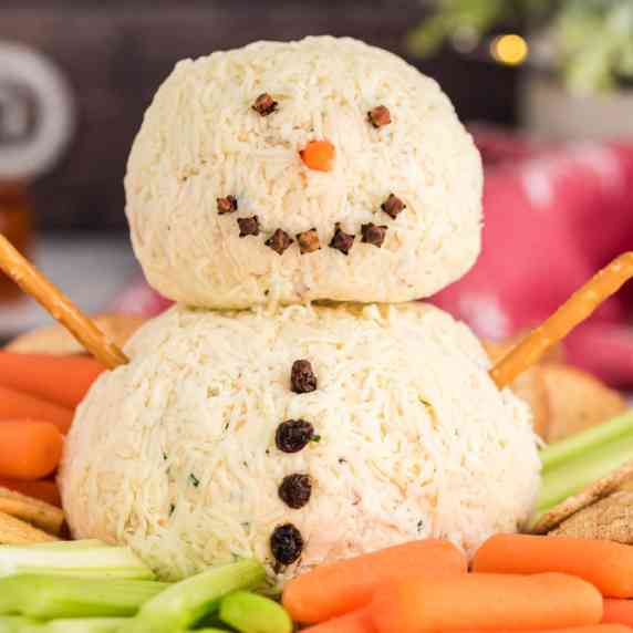 Smoky gouda cheese meets sundried tomatoes in this adorable snowman cheeseball. A fun and festive ap