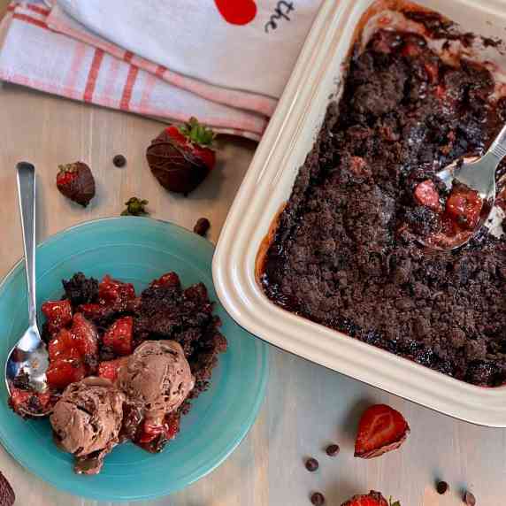 Picture of Strawberry Chocolate Crumble in a casserole dish and plated with chocolate ice cream. 