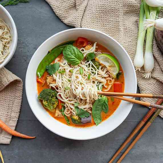 Thai curry ramen with snap peas, eggplant, red bell peppers, limes, broccoli and chop sticks