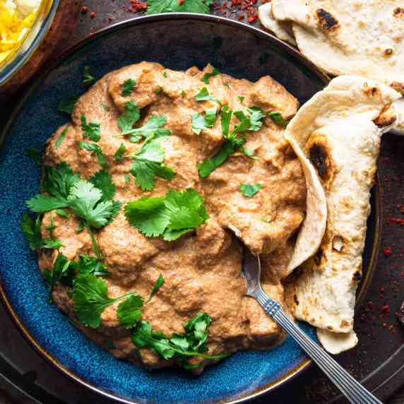 vegan paneer butter masala in a bowl with rice and roti bread