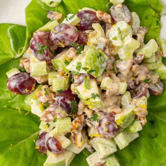 A colorful crisp salad with crunchy apples, plump grapes, and walnuts tossed in a mayo-based dressin