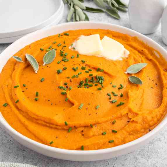 Bowl of whipped sweet potatoes with butter and sage